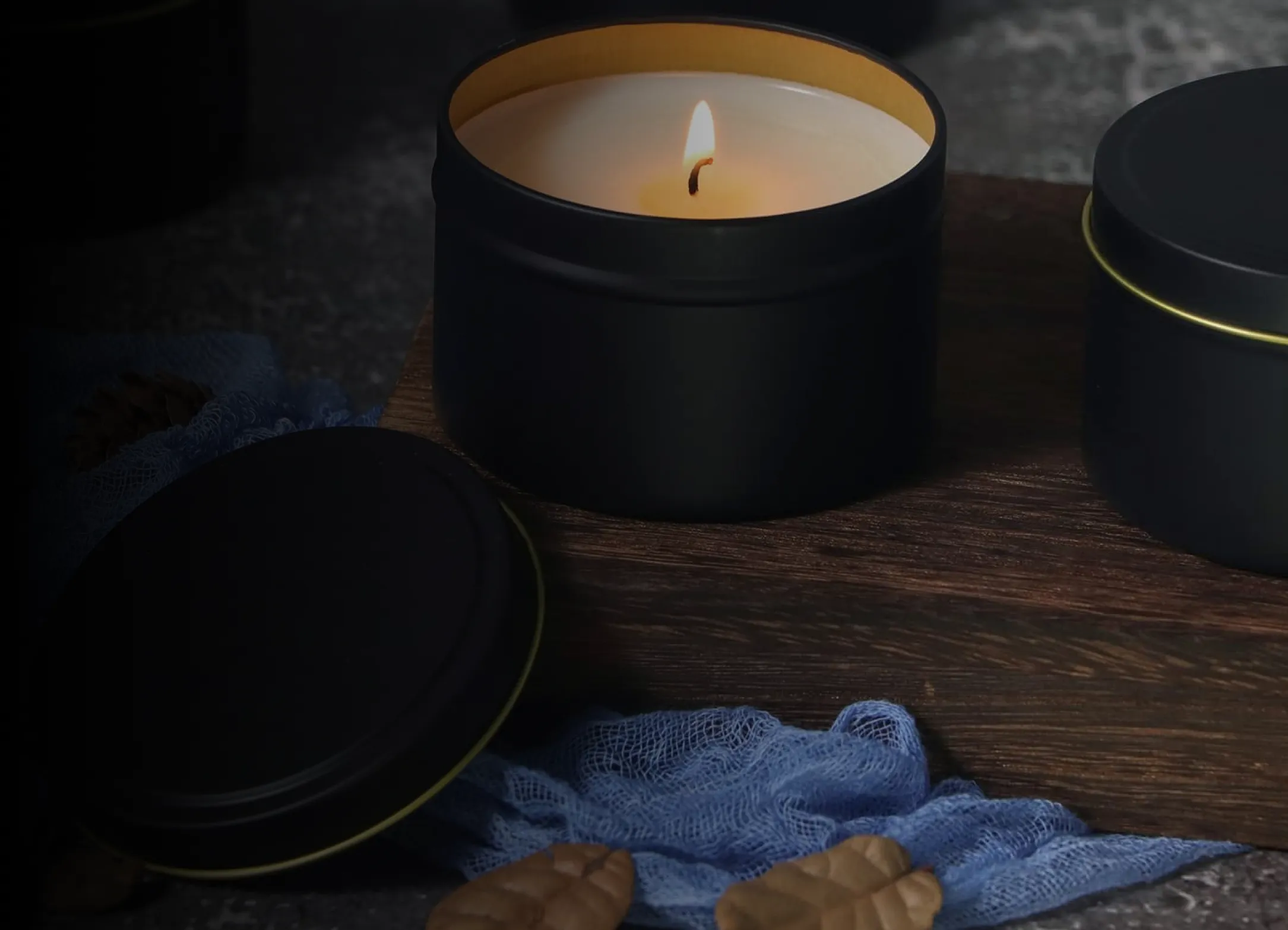 A candle sitting on top of a wooden table.